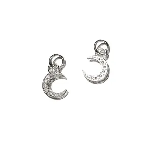 Macro view of sparkling 925 sterling silver moon pendants with delicate stone settings.