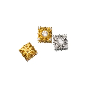 Macro detail of S925 sterling silver square spacer beads with intricate clear stone inlay.