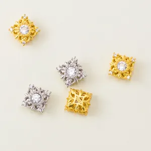 Detailed macro view of 925 sterling silver square filigree spacer beads with cubic zirconia