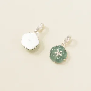 Detailed view showing both sides of a 925 sterling silver jade flower pendant accessory.