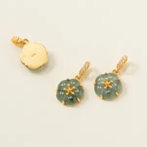 Detail view of 925 sterling silver gold-plated jade flower pendants for DIY jewelry making.