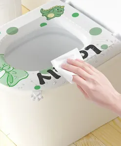 Close-up of wiping water off a waterproof EVA toilet seat cover with dinosaur pattern