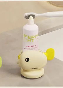 Detailed close-up view of the yellow whale toothpaste squeezer with suction base