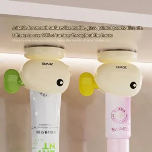 Whale shaped toothpaste squeezer with suction cup wall mount for bathroom organization