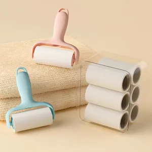 Set of portable mini lint rollers with pink and blue handles and six refill rolls