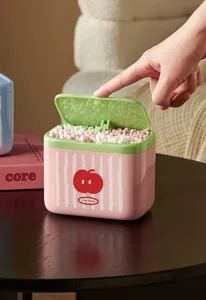 Detailed close-up of a pink and green cotton swab storage box with a cute apple pattern