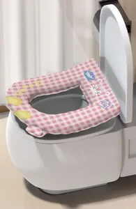 Close-up of a pink checkered cartoon toilet seat cover with waterproof texture