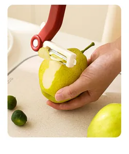Close-up detail of 3-in-1 stainless steel multi-function fruit peeler peeling a fresh pear