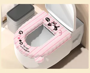 Close-up detail of pink striped waterproof toilet seat cover with cute cartoon cat pattern.
