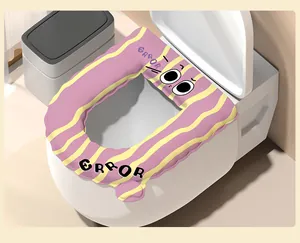 Close-up detail of a waterproof cartoon toilet seat cover with cute ERROR pattern and eyes.