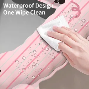 Waterproof pink cartoon toilet seat pad with striped pattern being wiped clean