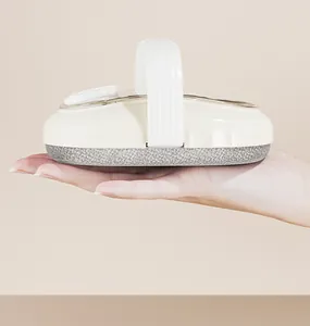 Macro view of cream liquid dispensing bath brush held in hand to show compact size