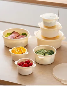 High-quality set of round beige food storage containers with lids on a wooden table