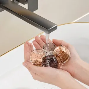 Washable thickened silicone chair leg protectors being rinsed under a modern faucet