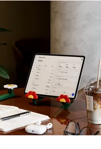 Floral design tablet stand shown supporting a device on a modern workspace desk