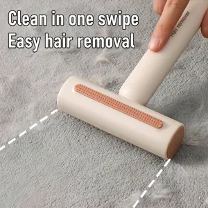 Efficient manual lint remover roller for pet hair cleaning on grey carpet surface