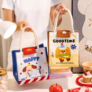 Detail view of two cute portable insulated lunch bags with cartoon illustrations