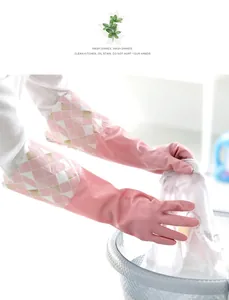 Pink patterned household cleaning gloves used for washing clothes in a basin