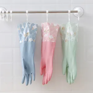 Three pairs of pastel colored household cleaning gloves with patterned cuffs hanging on a rack