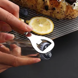 Manual stainless steel bottle opener with wooden handle opening a beverage bottle