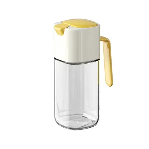 Transparent glass oil dispenser bottle with automatic flip lid and sturdy yellow handle