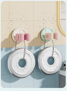 Strong suction cup mop holder showing heavy-duty capacity with hanging weights in bathroom.