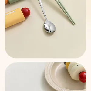 Close-up of stainless steel spoon and green chopsticks with a vibrant storage case