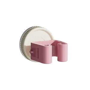 Pink suction cup mop and broom holder for wall-mounted bathroom storage without drilling