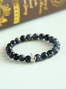 Close-up detail of a 925 silver snake charm on a black sunstone beaded bracelet.