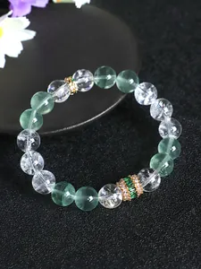Detail view of green fluorite and clear quartz beaded bracelet with gold crystal spacer