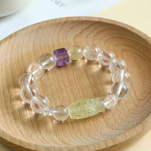 Handgemachtes Perlenarmband mit Bergkristall, Amethystwürfel und gelber Neun-Augen-Dzi-Perle.