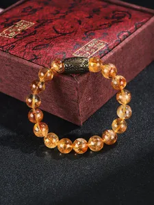 Vista detallada de pulsera de cuentas de cristal amarillo con cuenta de metal bronce vintage