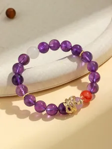 Detail view of amethyst beaded bracelet featuring a gold snake charm for Year of the Snake