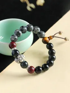 High-quality close-up of handmade 999 silver snake charm and onyx bead bracelet