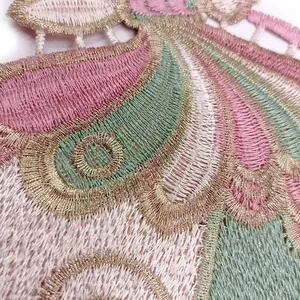 Detailed macro shot of intricate gold-threaded butterfly embroidery lace textures