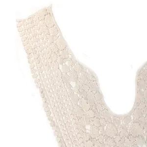Detailed close-up showing the intricate cotton thread embroidery on white lace collar