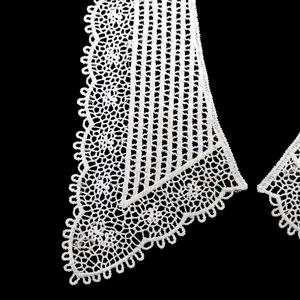 Close-up detail of white embroidered lace detachable collar with hollow pattern