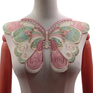 Detailed macro view of a large butterfly embroidered lace collar shown on a mannequin