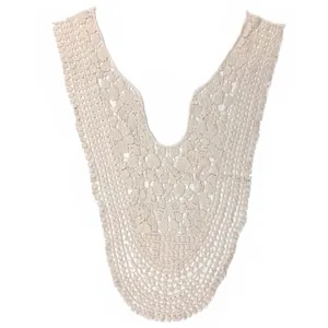 Detail of a beige cotton lace V-neck collar with intricate floral embroidery and hollow pattern