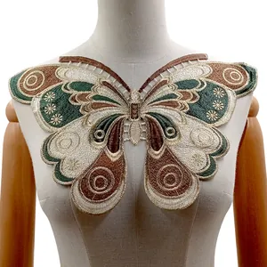 Detailed close-up of a large embroidered butterfly lace collar patch on a white mannequin