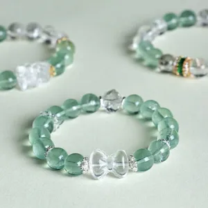 Elegant green fluorite and white crystal beaded bracelet with clear bow-knot detail