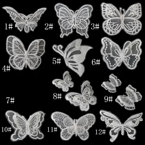 Zwölf verschiedene weiße Organza-Spitzen-Schmetterlings-Stickerei-Aufnäher auf Schwarz