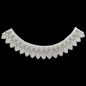 Detailed view of white water-soluble lace collar with intricate hollow embroidery