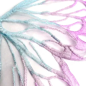 Close-up view of a gradient blue and purple butterfly embroidery patch on tulle