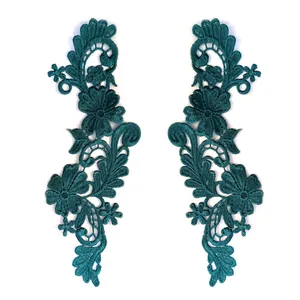 Detailed view of symmetrical teal 3D embroidered lace flower patches for DIY clothing