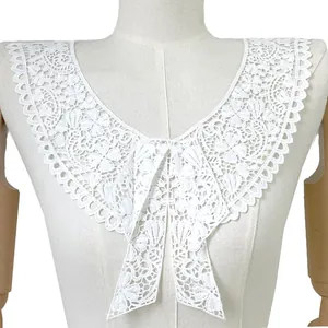 Close-up of white water-soluble lace collar featuring intricate butterfly floral embroidery