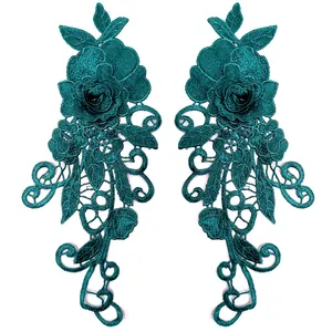 Detailed macro view of symmetrical teal 3D floral water-soluble lace patches for DIY sewing