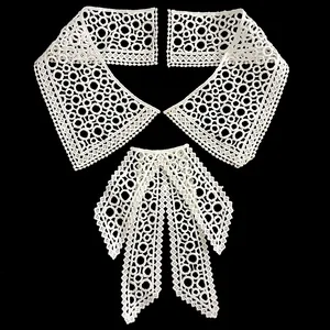 Detail of white water-soluble lace collar set with intricate hollowed patterns