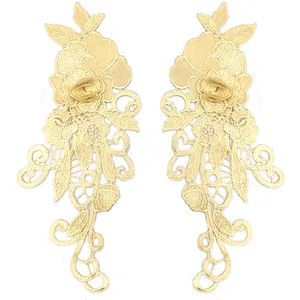 Detailed macro view of symmetric 3D water-soluble lace floral appliques in pale gold