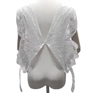 Close-up of white embroidered lace butterfly wings garment accessory on mannequin